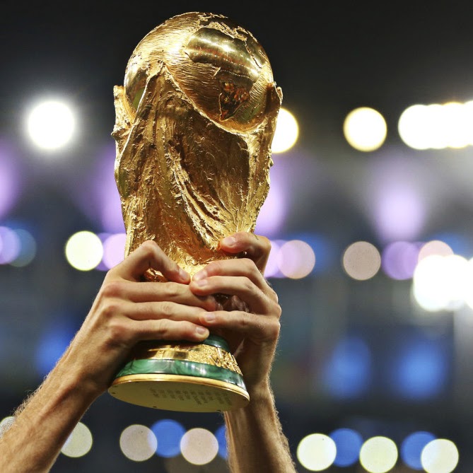 The FIFA World Cup trophy being held up